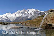 Foto F121044: Bergsee mit Wasserfall vor Schneebergen
